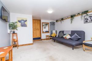 a living room with a couch and a table at The Old Dairy Mill Street in Crediton