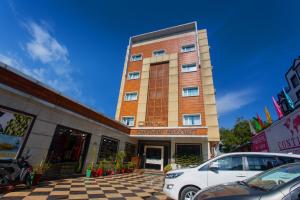 a building with a car parked in front of it at The Fern Residency Katra in Katra