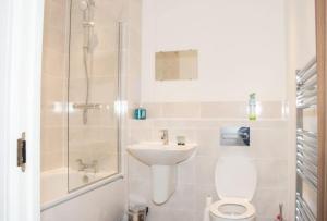 a bathroom with a toilet and a sink and a shower at TMS Beautiful 2 Bedroom Apartment!Ensuite!Dovestone Lakeside in West Thurrock