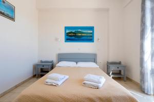 a bedroom with a bed with two towels on it at Vanas Apartments in Spetses