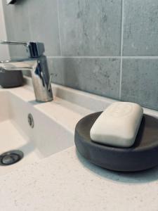a white appliance sitting on a bathroom sink at Maison en pierres au calme près d'Ancenis in Mésanger +11 photos
