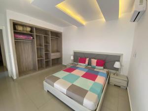 a bedroom with a bed with a colorful blanket at belle villa avec piscine 100% sans vis à vis in Midoun +14 photos
