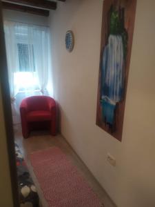 a room with a red chair and a window at D & G in Split