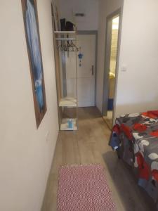 a hallway of a room with a bed and a rug at D & G in Split