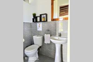 łazienka z toaletą i umywalką w obiekcie Raisin House w mieście Koukounariá