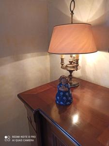 a lamp sitting on top of a wooden table at Villa Rossi in Polignano a Mare