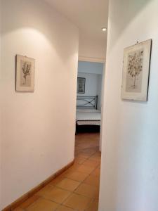 a hallway with two pictures on the wall and a bed at Villa Rossi in Polignano a Mare