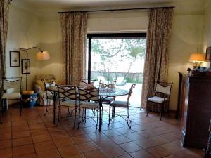 a dining room with a table and chairs and a window at Villa Rossi in Polignano a Mare