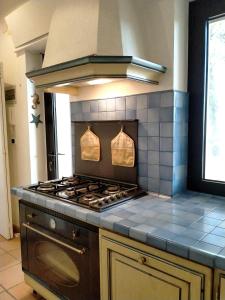 a kitchen with a stove top oven in a kitchen at Villa Rossi in Polignano a Mare