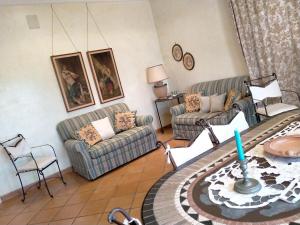 a living room with two couches and a table at Villa Rossi in Polignano a Mare