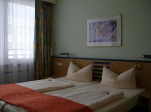 Postel nebo postele na pokoji v ubytování Superior Hotel Präsident