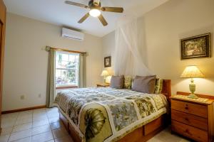a bedroom with a bed with a ceiling fan and a window at El Gran Castillo De Arena in San Pedro +32 photos