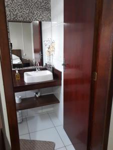 a bathroom with a sink and a mirror at Pousada Cravo e Canela SJ in São Joaquim +21 photos