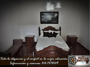 a bedroom with a large bed and two night stands at Las Marías Family Home in Salamina