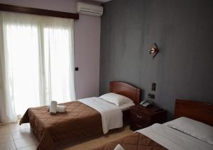 Postel nebo postele na pokoji v ubytování Filippion Hotel