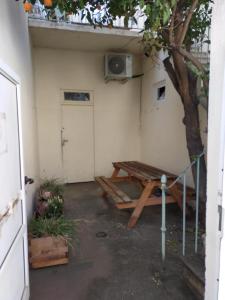 a patio with a picnic table and a tree at T3 COSY REFAIT A NEUF PROCHE GARE in Perpignan