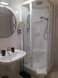 a white bathroom with a shower and a sink at meraviglia in Savona +22 photos