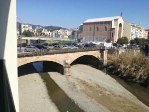 a bridge over a river in a city with cars at meraviglia in Savona