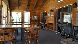a dining room with a table and some chairs at Auberge Ma Maison in Sainte-Melanie