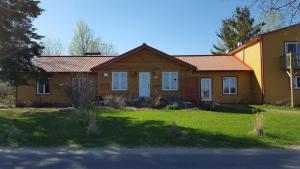 a house with a grass yard in front of it at Auberge Ma Maison in Sainte-Melanie