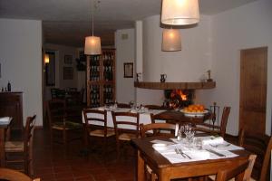 a dining room with tables and chairs and a fireplace at La Locanda Cuccuini in Cavriglia