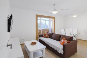 a living room with a couch and a table at Apartamento Murillo in Barbate