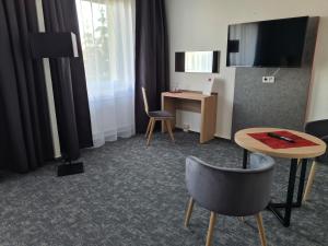 TV a/nebo společenská místnost v ubytování Hanse-Hotel Stendal