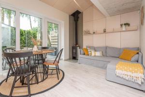 a living room with a couch and a table and chairs at Stunning Seaside Haus 3 in Palanga