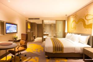 a hotel room with a large bed and a desk at Crowne Plaza Vientiane, an IHG Hotel in Vientiane