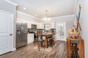 a kitchen with a table and a refrigerator at Gorgeous Cades Cove Condo with Community Pool in Townsend