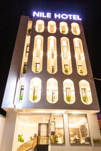 a building with a nile hotel lit up at night at Nile Hotel in Tuy Hoa