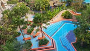 an overhead view of a swimming pool with palm trees at Lahabana HuaHin pool view 137 in Hua Hin