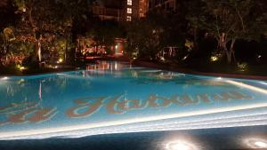a swimming pool at night with a sign on it at Lahabana HuaHin pool view 137 in Hua Hin
