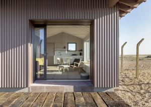 an open door of a building with a table and chairs at Radar by Bloom Stays in Littlestone-on-Sea