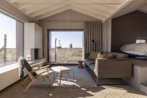 a bedroom with a bed and a living room with a couch at Radar by Bloom Stays in Littlestone-on-Sea