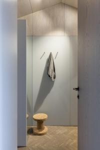 a bathroom with a shower with a stool and a towel at Radar by Bloom Stays in Littlestone-on-Sea +10 photos