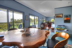 a dining room with a wooden table and chairs at Treetops in Agnes Water