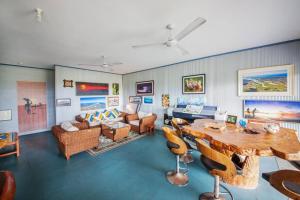 a living room with a table and a couch at Treetops in Agnes Water