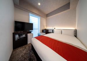 Postel nebo postele na pokoji v ubytování DEL style Ikebukuro Higashiguchi by Daiwa Roynet Hotel