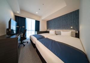 Postel nebo postele na pokoji v ubytování DEL style Ikebukuro Higashiguchi by Daiwa Roynet Hotel