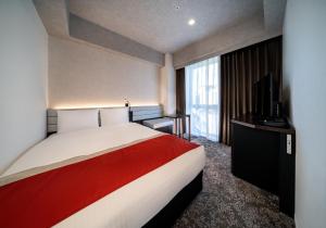 Postel nebo postele na pokoji v ubytování DEL style Ikebukuro Higashiguchi by Daiwa Roynet Hotel
