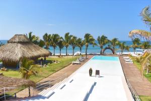 a view of a resort with a swimming pool and the beach at Selina Mancora in Máncora