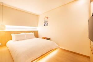 Lova arba lovos apgyvendinimo įstaigoje Tomonoya Hotel and Ryokan Gyeongju