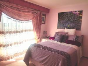 a bedroom with a large bed and a window at Heavenly Farm B & B Tasmania in Boat Harbour