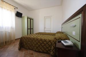 a hotel room with a bed and a phone on a table at Casale Malva in Narni