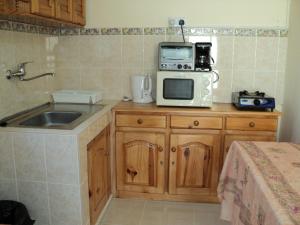 a kitchen with a sink and a microwave at Monalysa Villa & Monalysa Studio in Grand Baie +21 photos
