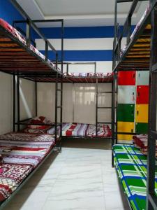 a room with three bunk beds in it at Song Huong Hotel Mui Ne in Mui Ne