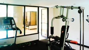 a room with a gym with a treadmill at RedDoorz Plus @ Mabolo Cebu in Cebu City