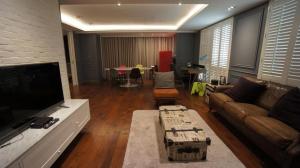 a living room with a couch and a flat screen tv at 朵兒dor韓國汗蒸幕 동대문점 商務旅店 in Taipei