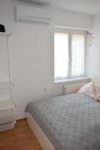 Postel nebo postele na pokoji v ubytování La Siesta Bogács Apartman